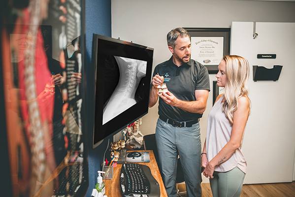Chiropractor The Colony TX Andrew Oteo Showing Patient X-rays